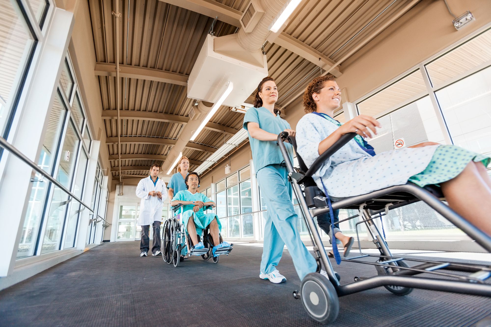 Nurse Assisting Patients With Wheelchair